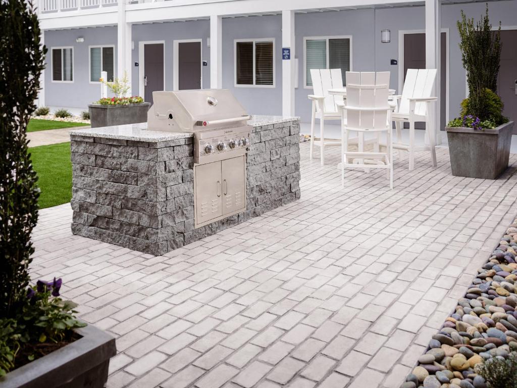 a patio with a barbecue grill in a yard at stayAPT Suites Killeen-Fort Cavazos in Killeen