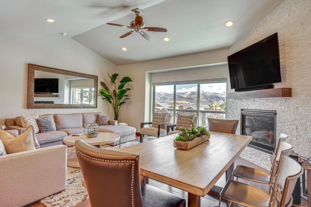 a living room with a table and a couch at Park City Townhome with Hot Tub and Mountain Views! in Heber City