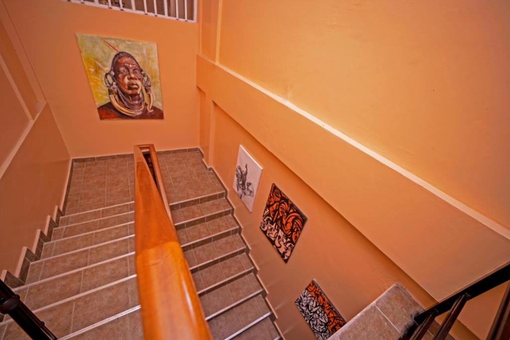 a set of stairs with stickers on the wall at Kibibi Lake view furnished suites in Wakiso