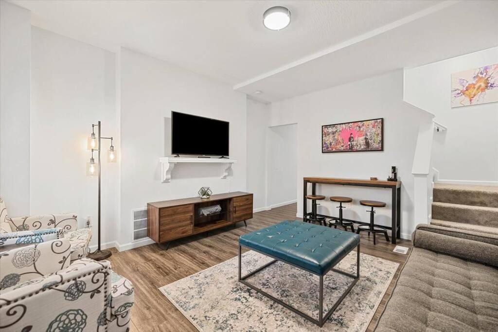 a living room with a couch and a table at Centrally located renovated home in Columbus