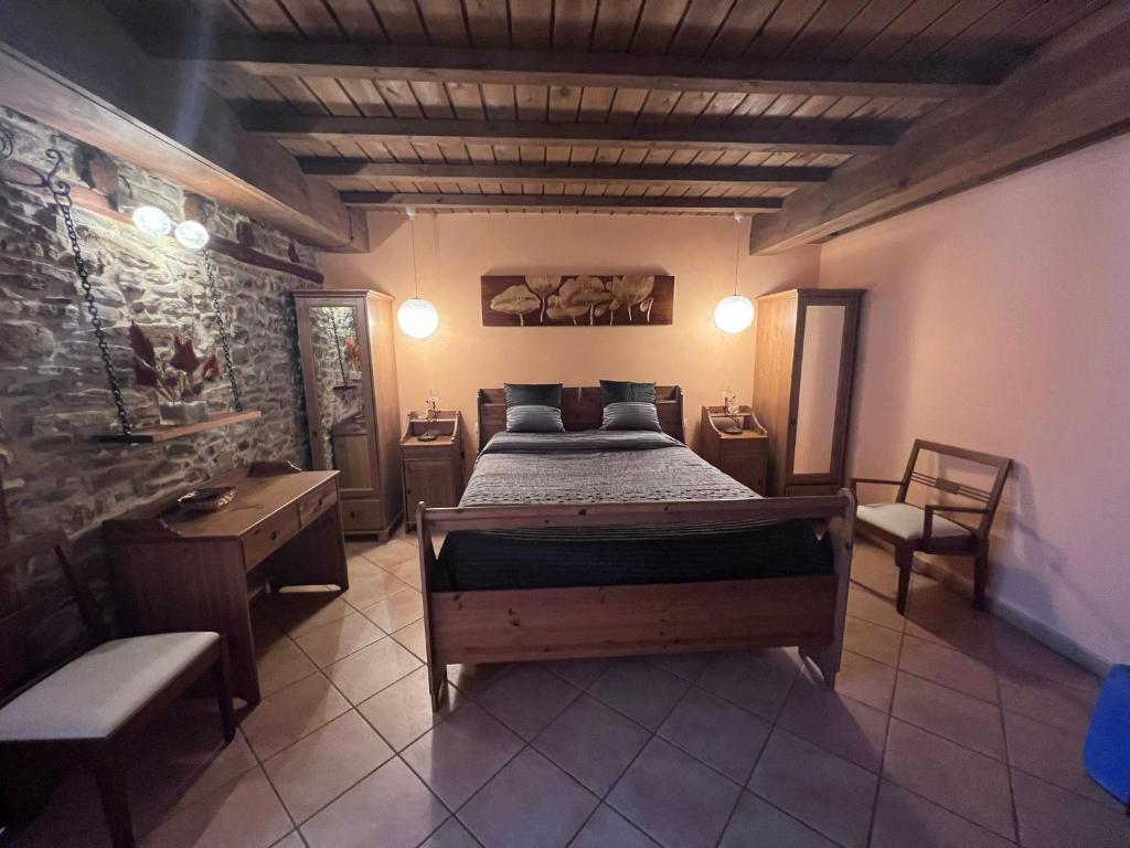 a bedroom with a bed and a table and chairs at Hotel rural Casa la Juana in Almarza