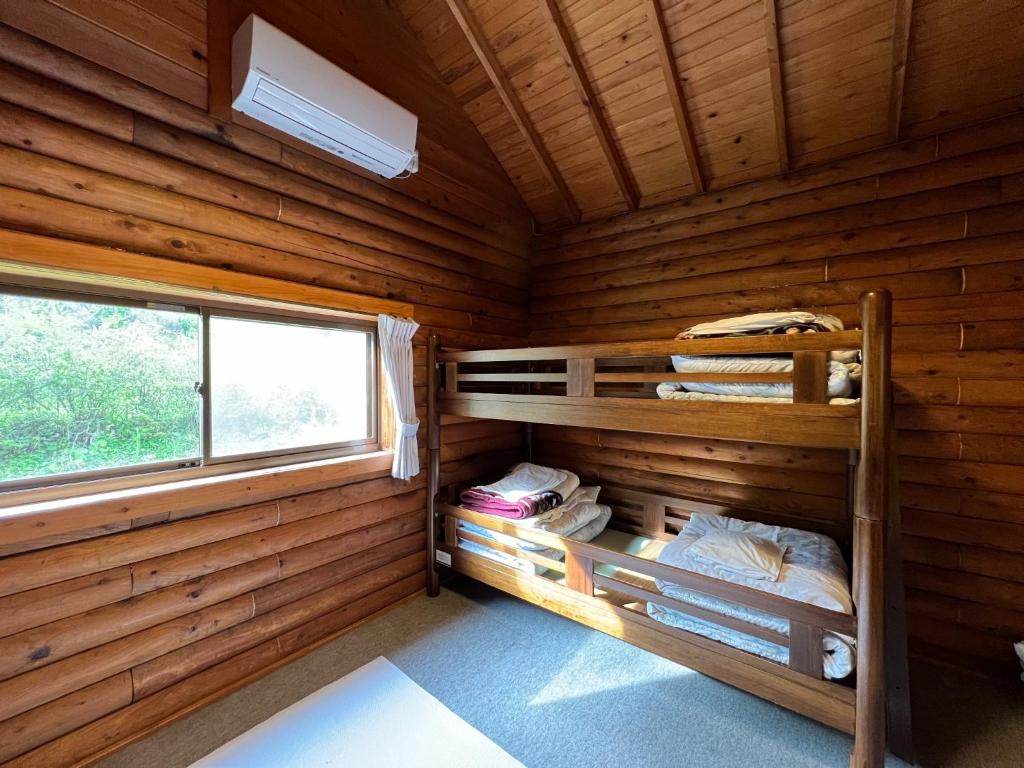 a log cabin with bunk beds in it at Nasu Takahara Auto Campsite - Vacation STAY 42065v in Nasushiobara