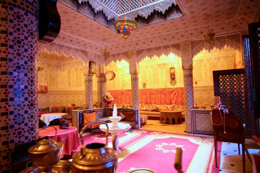 a large room with a couch and a table at Dar Merzouga Meknes in Meknès