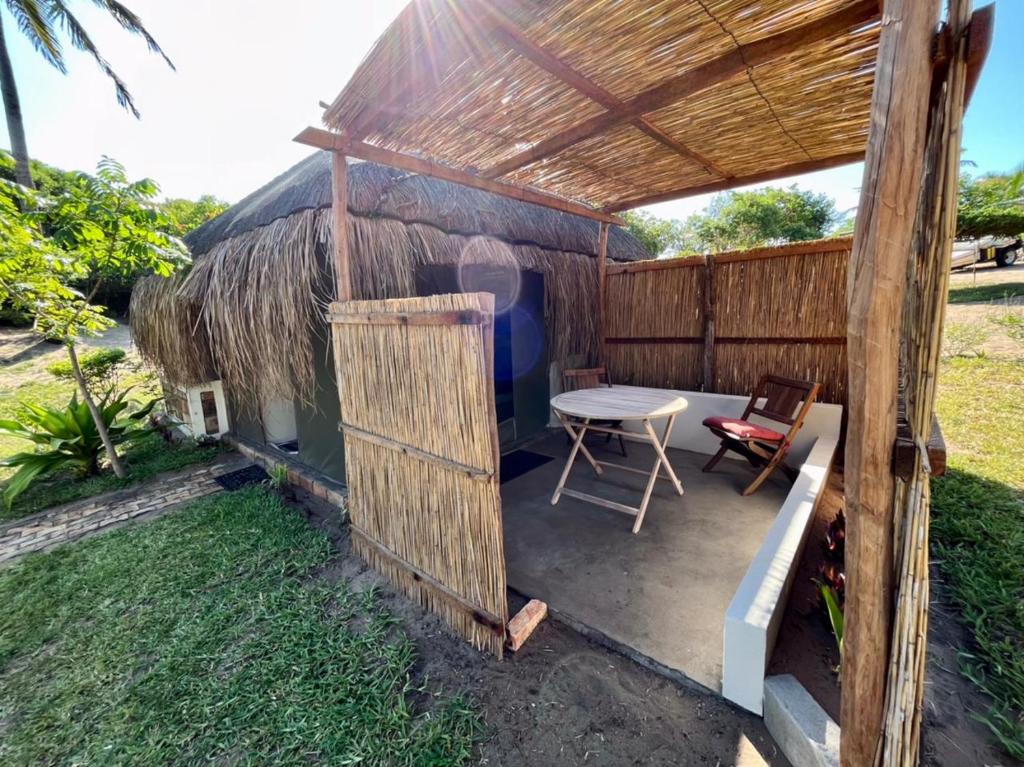 a small hut with a table and chairs in it at Vista Do Deus Resort in Ligogo