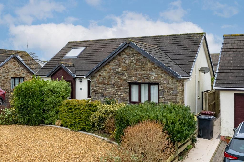 a brick house with a black roof at Kittiwake - Short Walk to Beach and Village in Saundersfoot