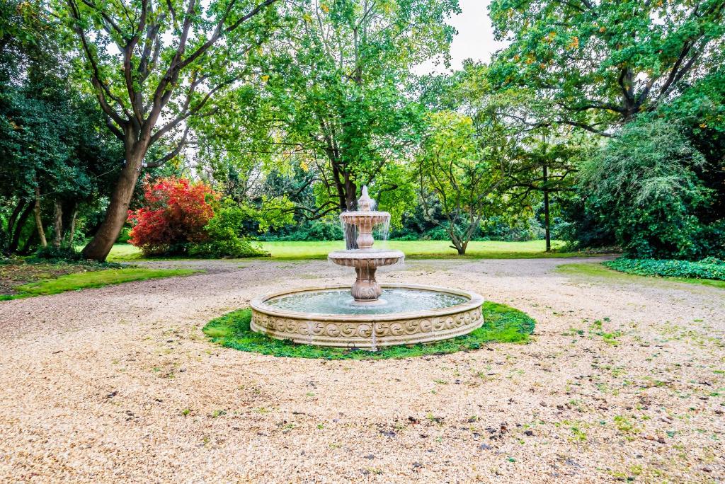 a fountain in the middle of a park at Royal Windsor Country Estate Private 5 Acres of Gardens in Windsor
