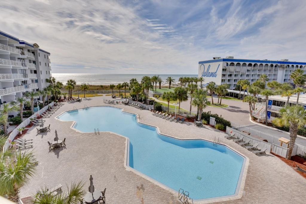 an overhead view of a swimming pool at a resort at Sunny Fort Walton Beach Condo - Walk to Ocean! in Fort Walton Beach