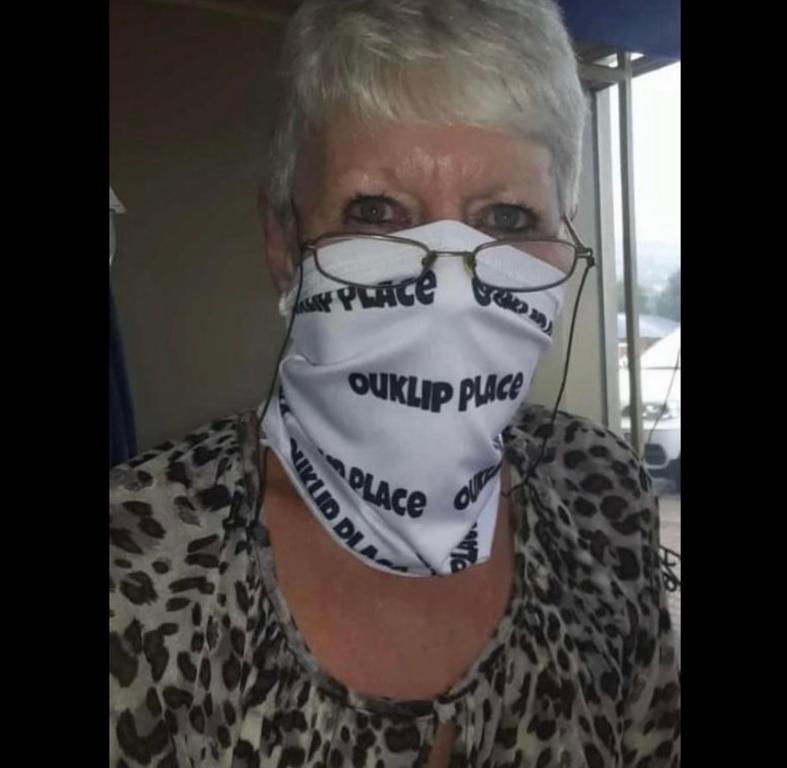 a woman wearing a face mask with the words outrunride on it at Ouklip Place Hotels in Roodepoort