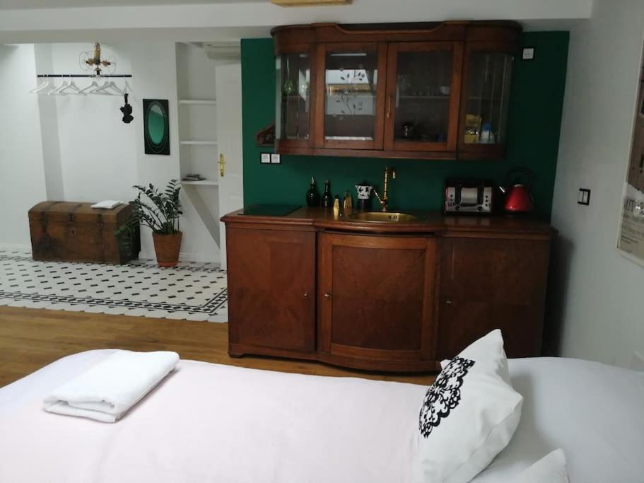 a bedroom with a bed with a sink and a cabinet at Z widokiem- Old Town in Kraków