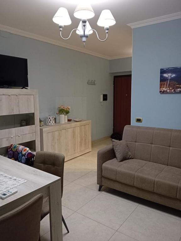 a living room with a couch and a table at Casa Irene in Catania