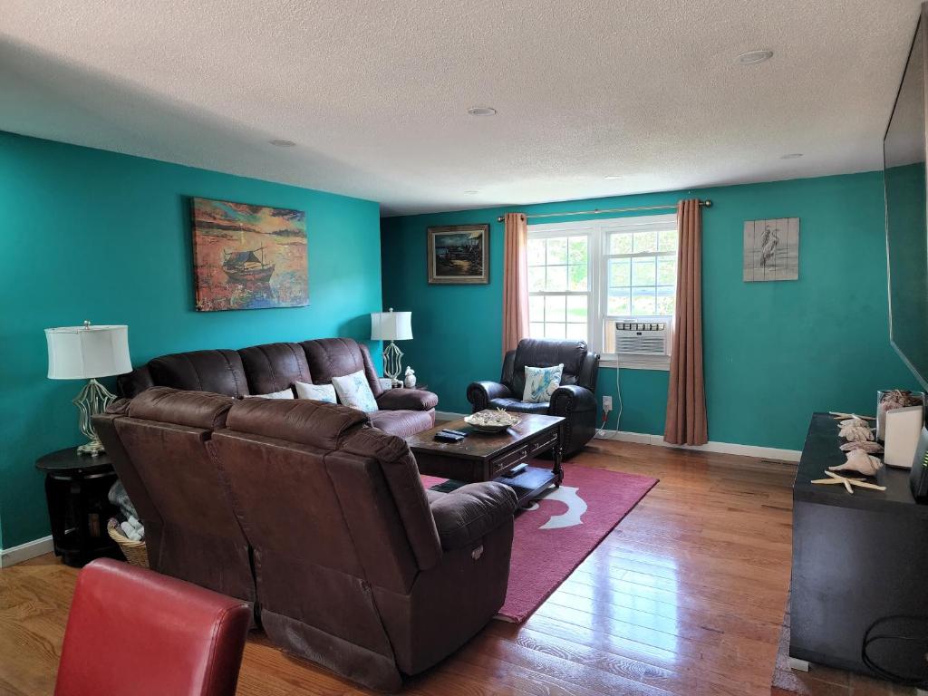 a living room with a couch and a table at Summer Sea Vacation Rental in South Yarmouth