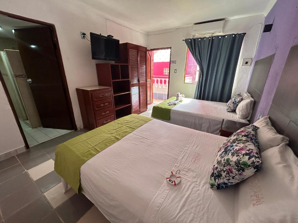 Postel nebo postele na pokoji v ubytování Hotel Capri Playa a una calle de la Playa Regatas