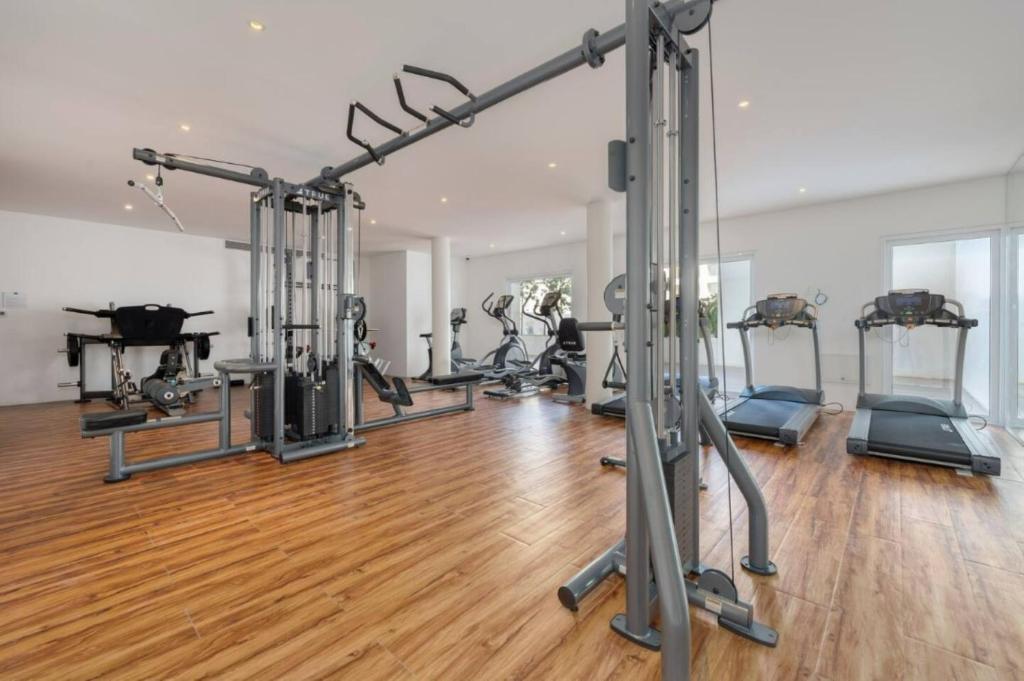 a gym with several tread machines in a room at Lumina at Marea Cabo San Lucas in Cabo San Lucas
