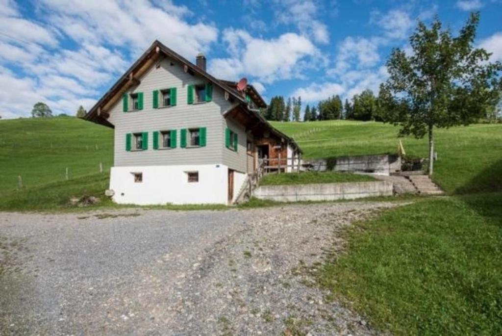 a house on a hill with a gravel road at Haus Eberli-Bussmann - b48553 in Giswil