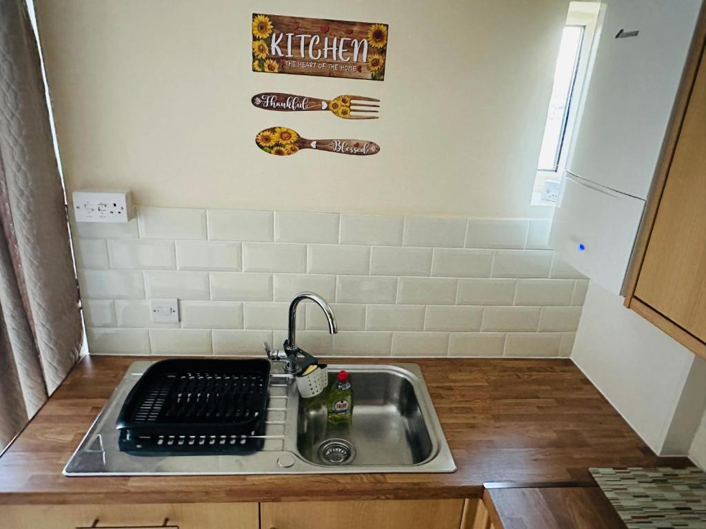 a kitchen counter with a sink in a kitchen at Your Staycation in Bristol