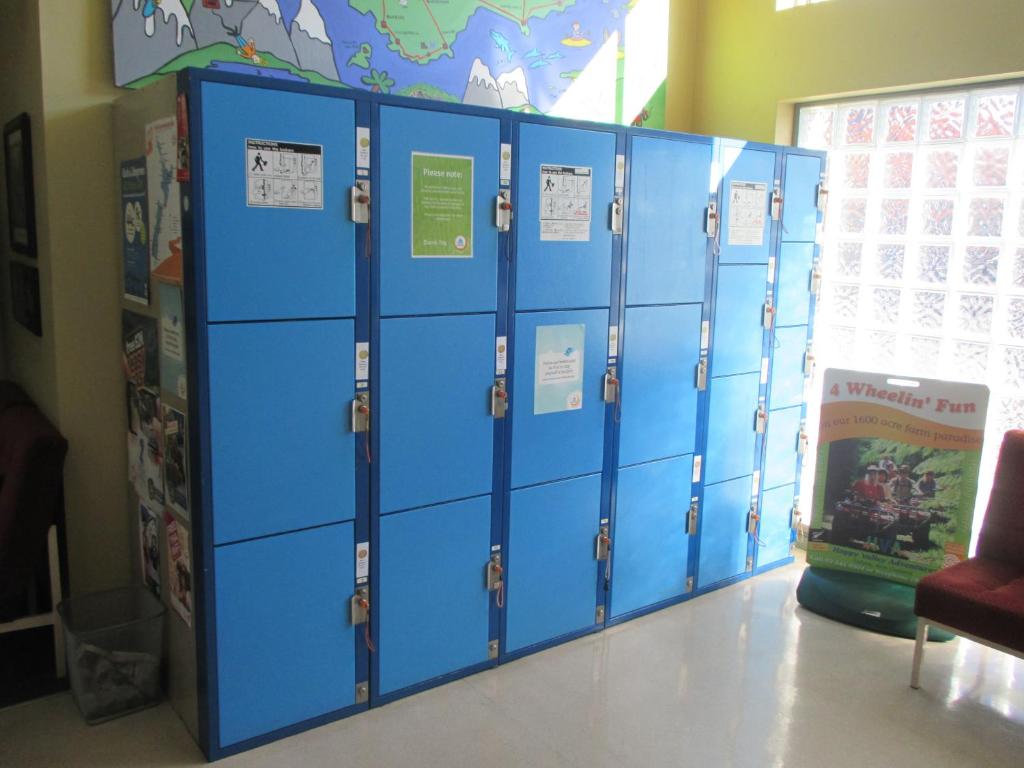 a row of blue lockers in a room at YHA Nelson in Nelson