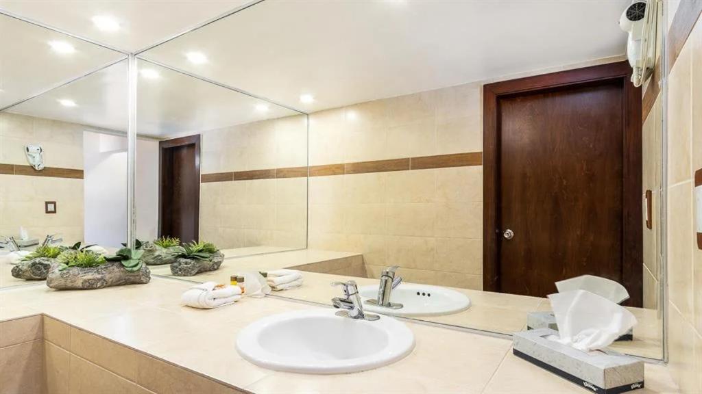 a bathroom with a sink and a mirror at Puerto Nuevo Baja Hotel & Villas in Rosarito