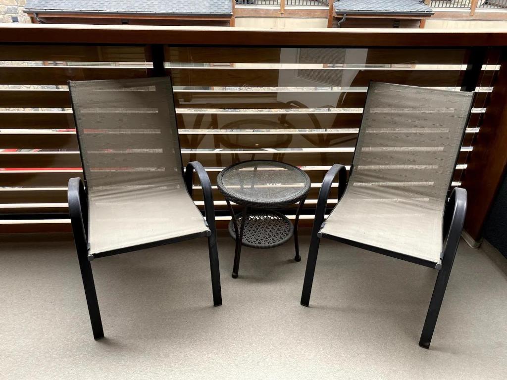 two chairs and a table in front of a counter at Luxury unit in the heart of Canmore in Canmore