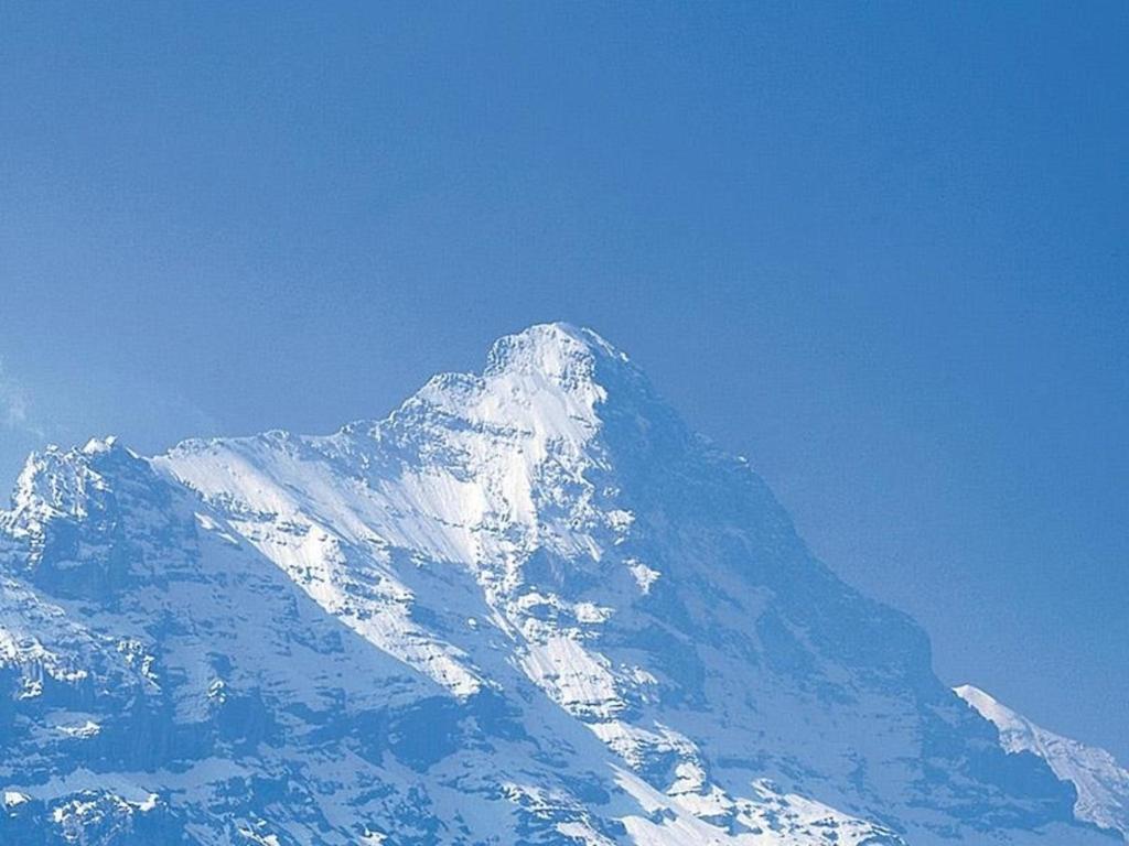 a snow covered mountain with a blue sky at Tournelle 8 Bett Wohnung - b48643 in Grindelwald