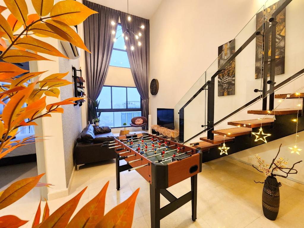 Loft Suite JB Town near CIQ 7Pax في جوهور باهرو: غرفة معيشة مع كرة قدم على طاولة