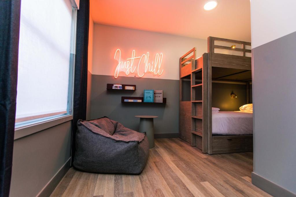 a small room with a bunk bed and a sign at The Darwin Hotel in Atlanta