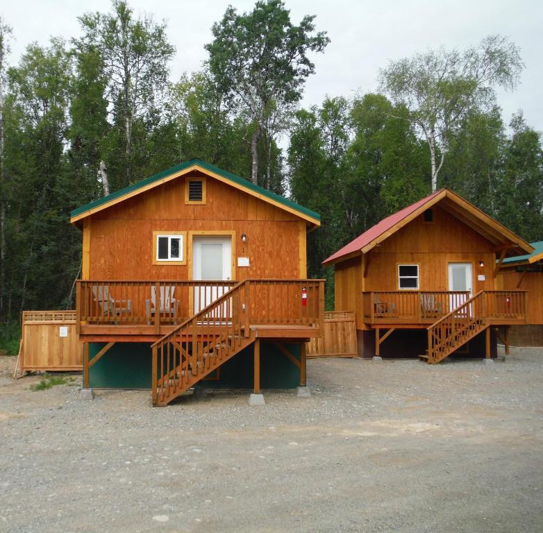 a house with a wooden deck and wooden stairs at Talkeetna Love-Lee Cabins in Talkeetna