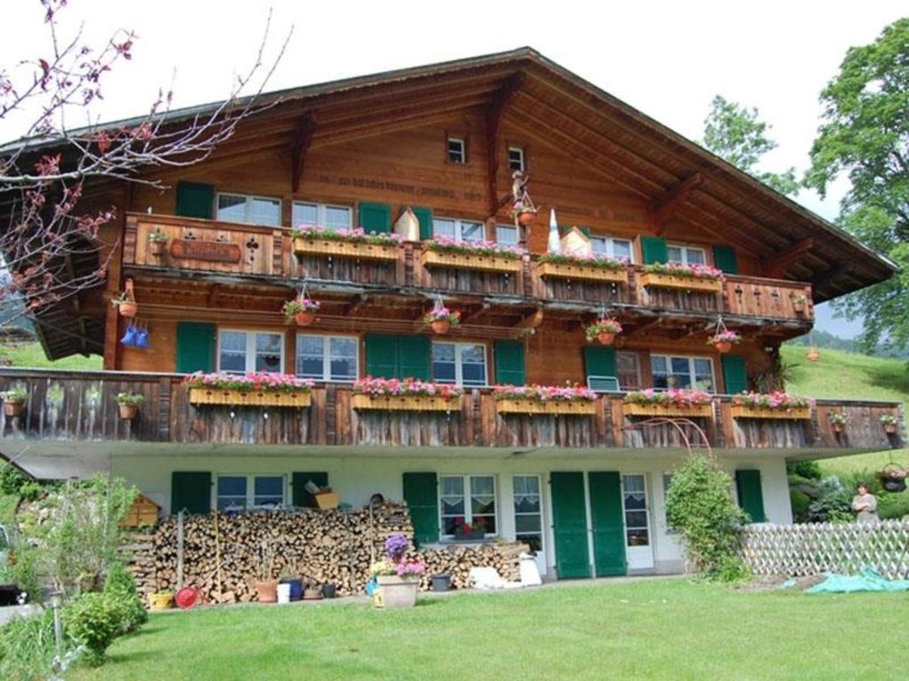 a large wooden house with balconies on it at Chalet Burgstein, Wohnung Silberdistel - b48794 in Grindelwald