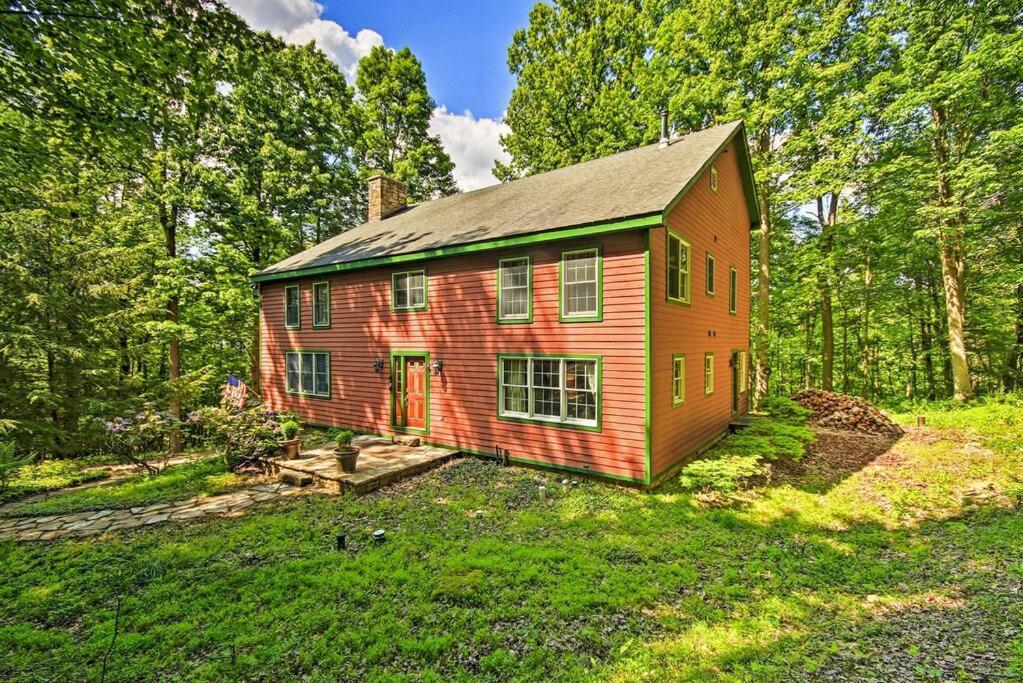 a red house in the middle of a field at Bear's Eye View - Mountain Retreat w/ Hot Tub! in Acme