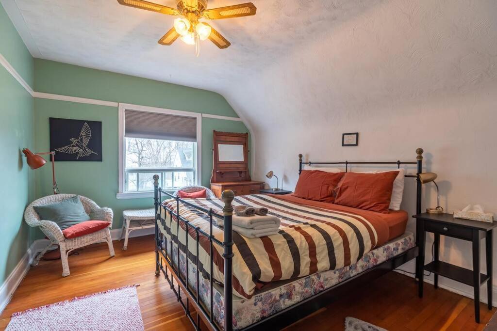 a bedroom with a bed and a ceiling fan at Charming Townhouse, Historic Hydrostone in Halifax