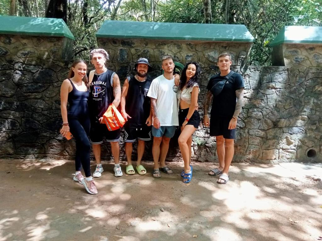 a group of people standing in front of a stone wall at Akein Jungle Resort - Sigiriya in Sigiriya
