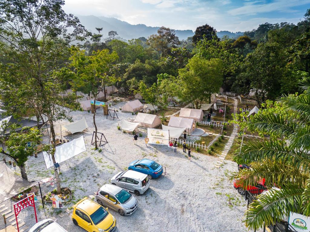 a group of cars parked in a parking lot at De Kampung Campsite in Rawang
