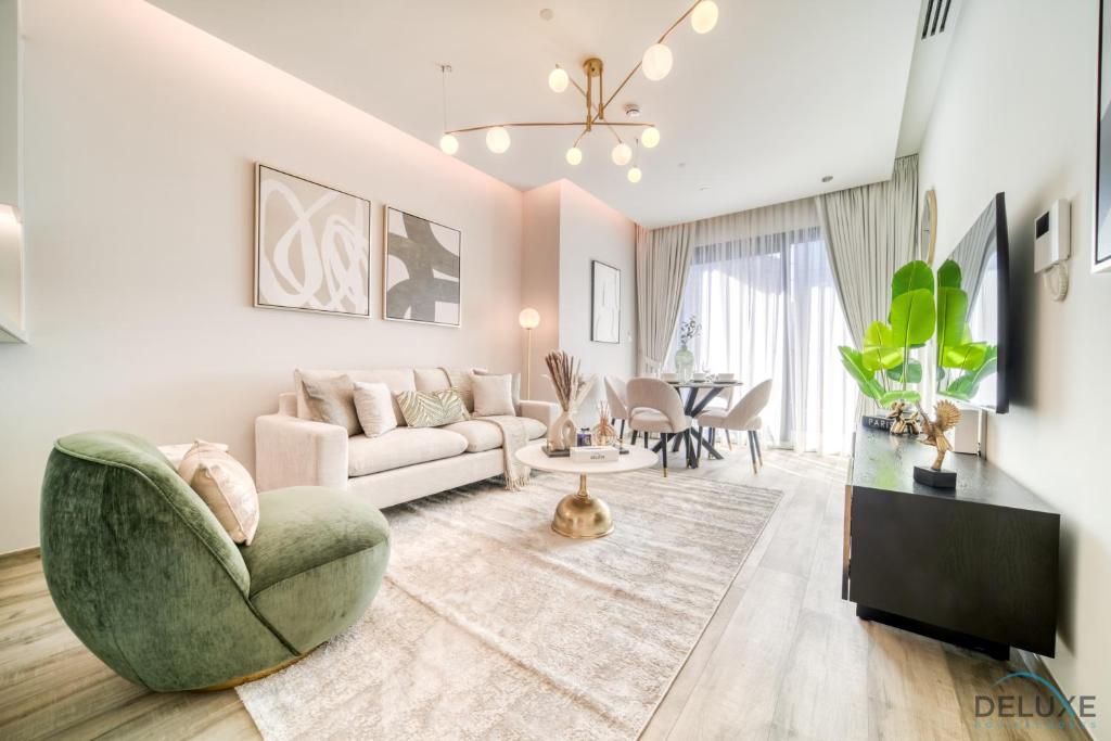 a living room with a couch and a table at Convenient 1BR at Ahad Residences Business Bay by Deluxe Holiday Homes in Dubai