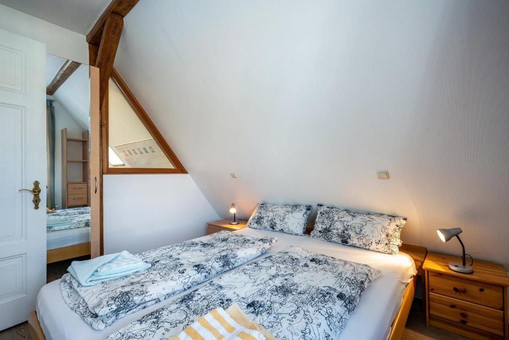 a bedroom with a bed and a mirror at Haus Übersee Wohnung Sansibar in Travemünde