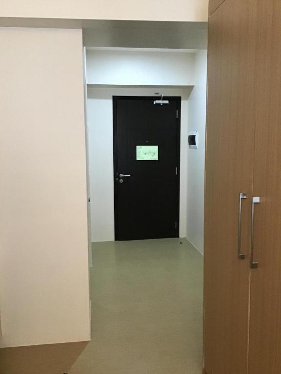 a black door with a sign on it in an empty room at Studio Type Bedroom in Iloilo City