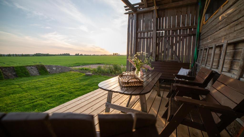 a deck with a table and chairs on a house at Grannys cottage in Laihia