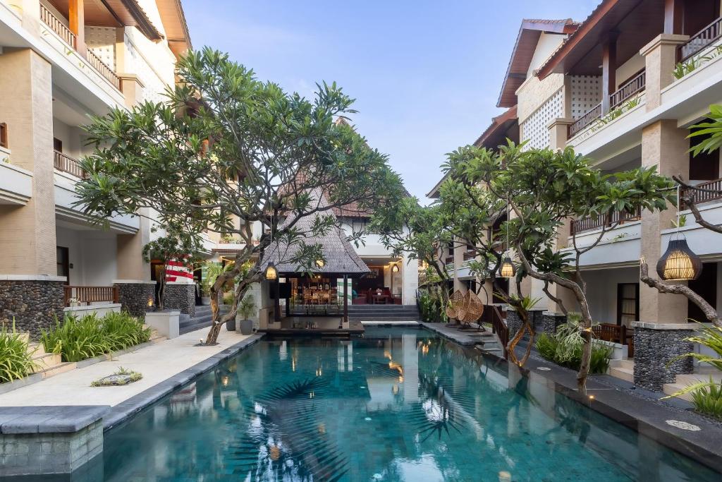 a swimming pool in the middle of a building at Fourteen Roses Beach Hotel in Legian