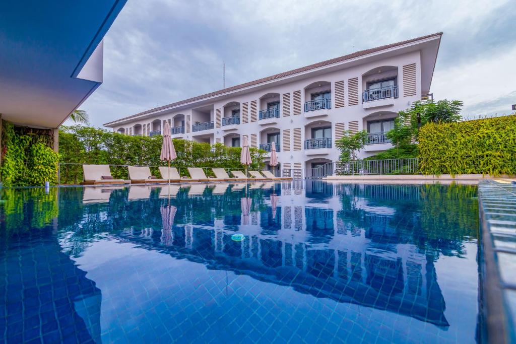 a hotel swimming pool in front of a building at Damrei Residence & Spa in Siem Reap