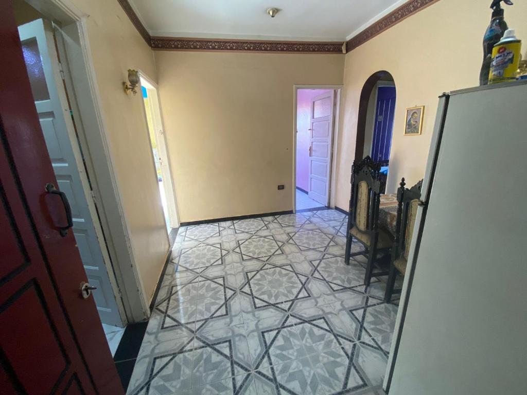a hallway with a tile floor and a door at Mayane home in Luxor