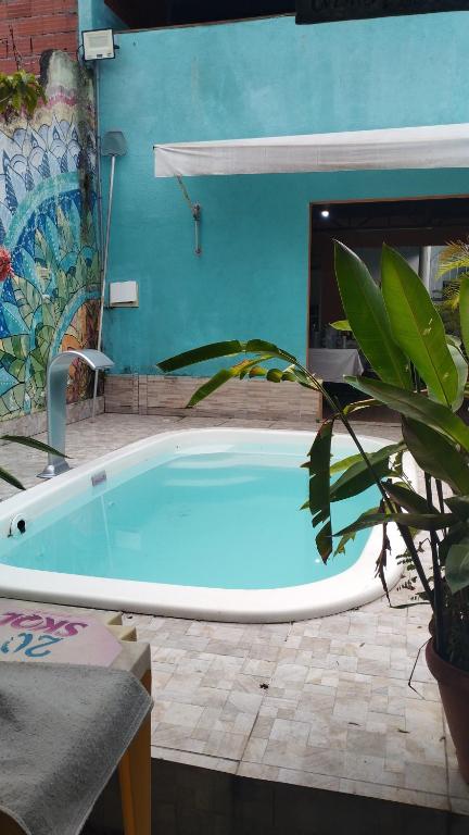 una bañera grande en un patio con una planta en Equilibra Soul en Caraguatatuba