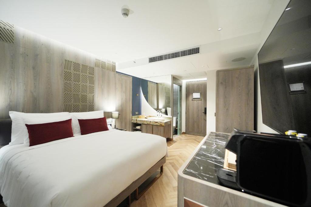 A bedroom view toward the vanity, entry door and compact refreshment station.