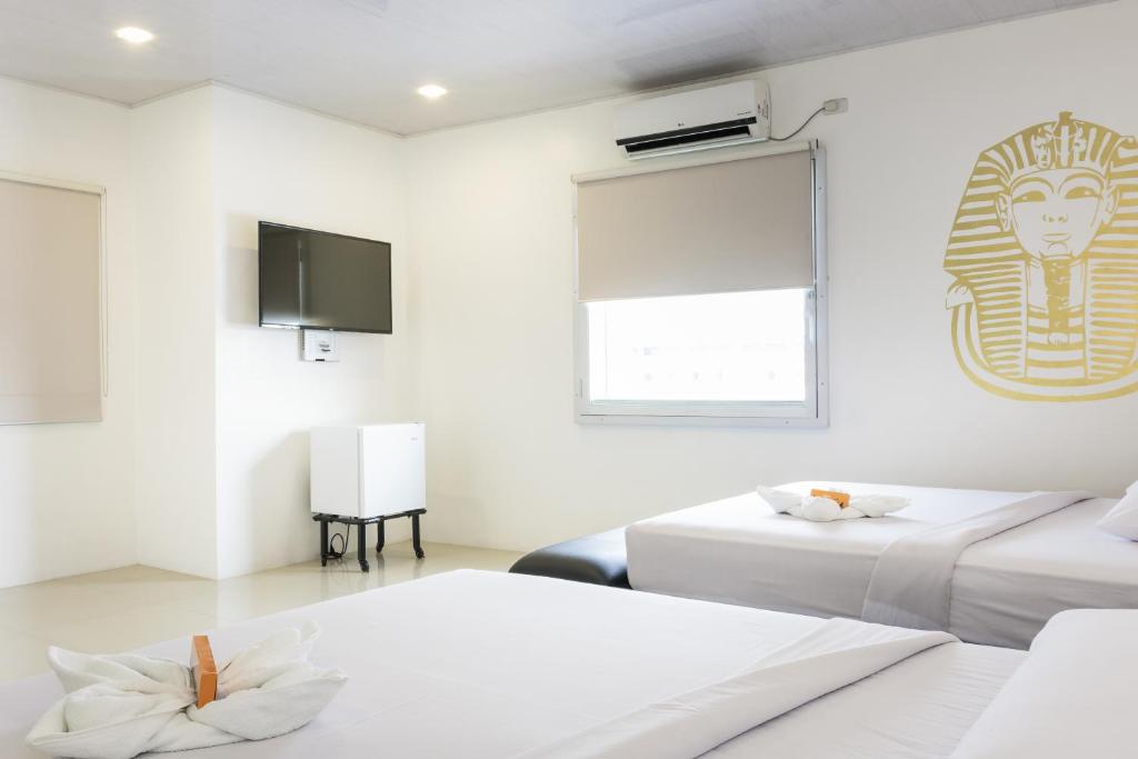 Postel nebo postele na pokoji v ubytování GC Suites