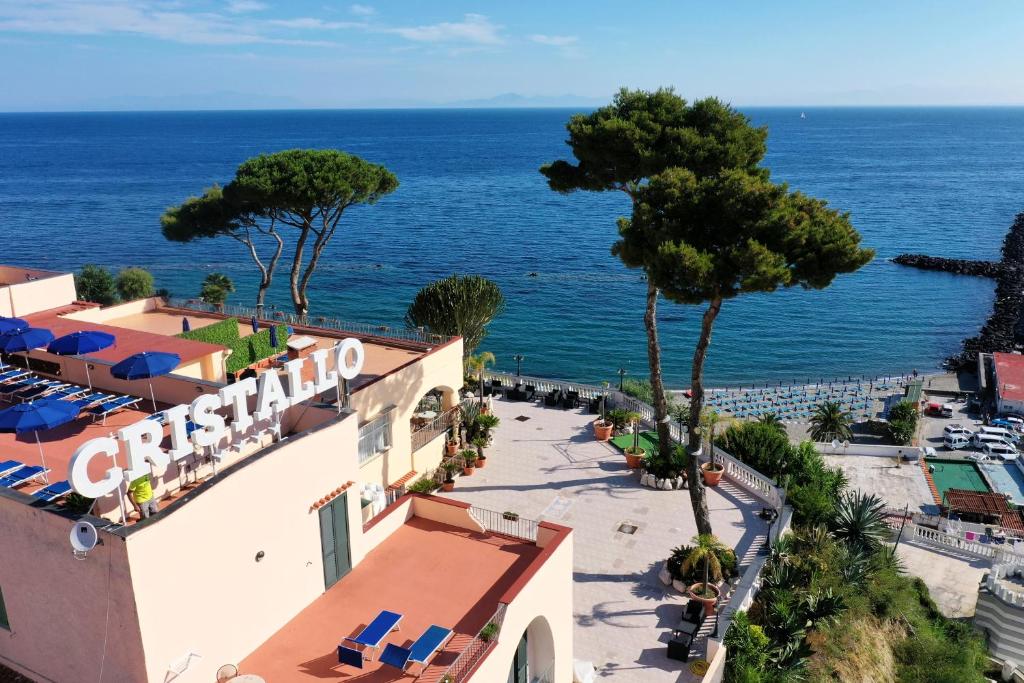 a view of a hotel with the ocean in the background at Hotel Terme Cristallo Palace & Beach in Ischia