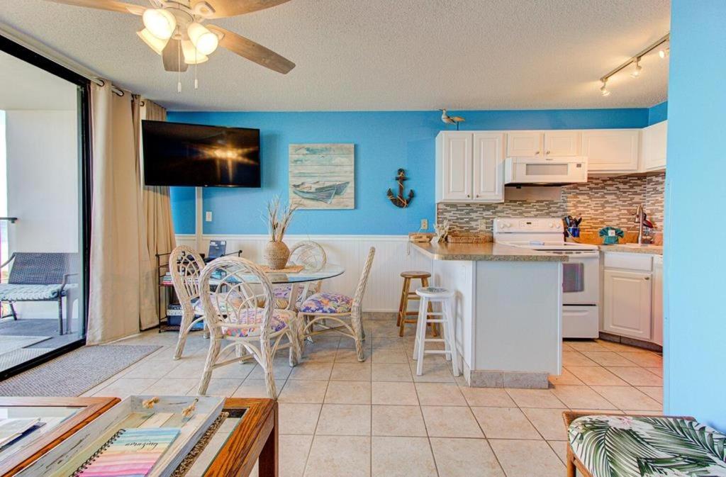 a kitchen and dining room with a table and chairs at 0305 Mako Your Dreams Come True by Atlantic Towers in Carolina Beach