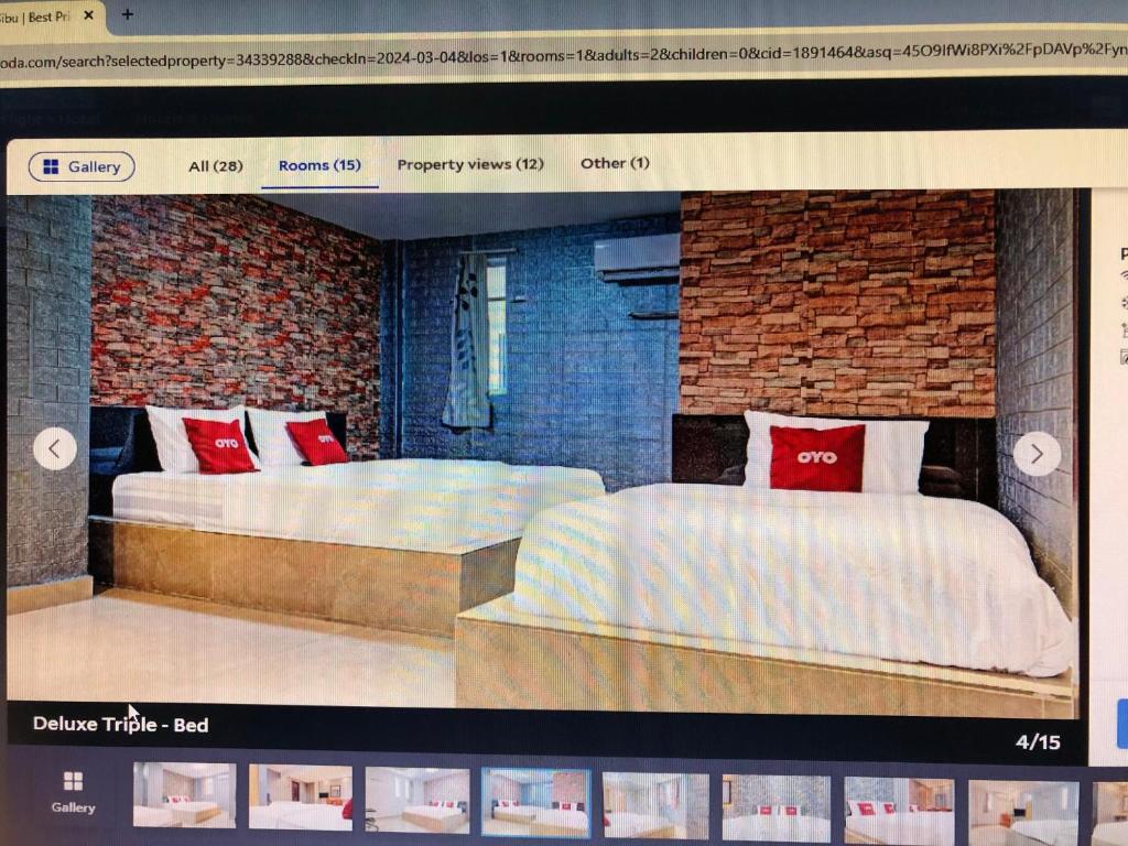 a website of a hotel room with two beds at City hotel in Sibu