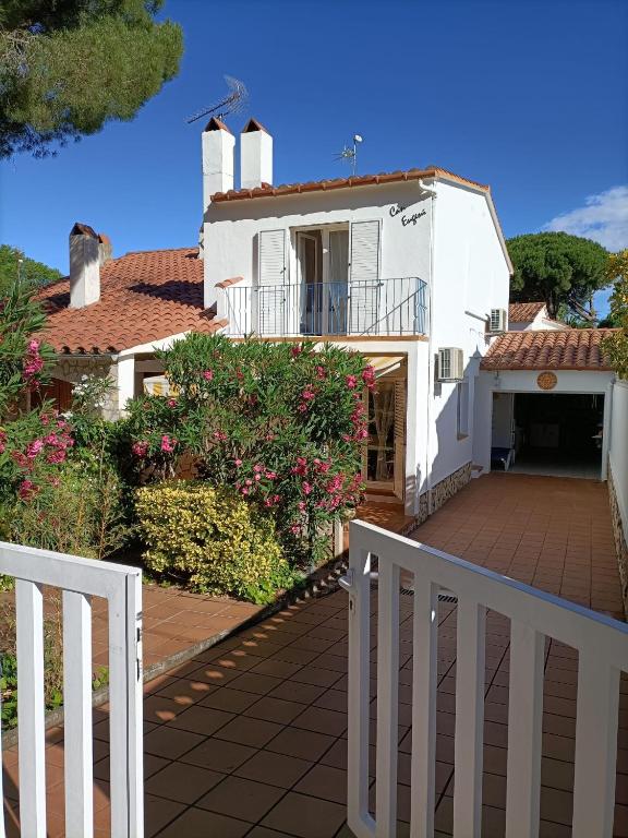 a white fence in front of a white house at Can Eugeni in L'Escala