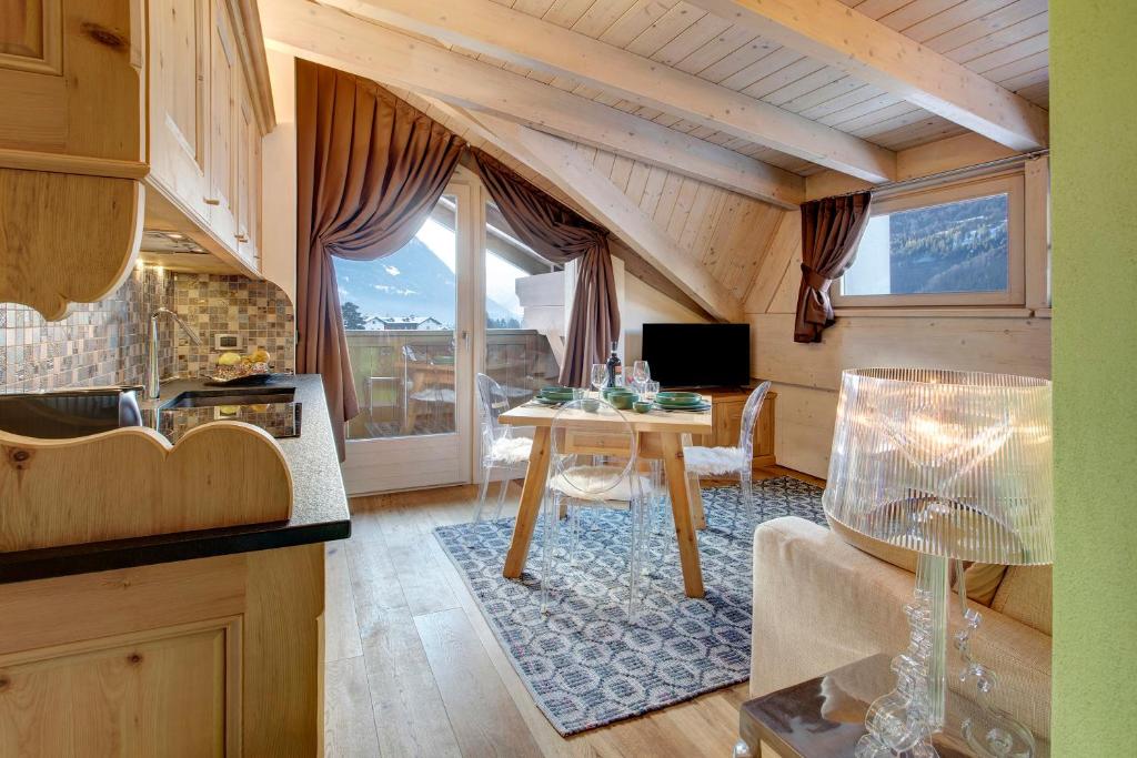 a kitchen and living room with a table in a room at Chalet Meridiana in Bormio