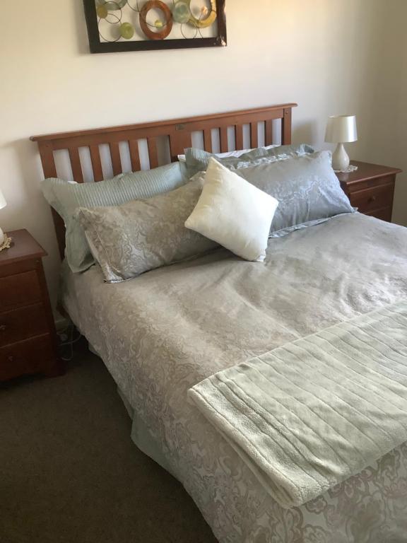a bed with pillows on it in a bedroom at City haven in Whanganui