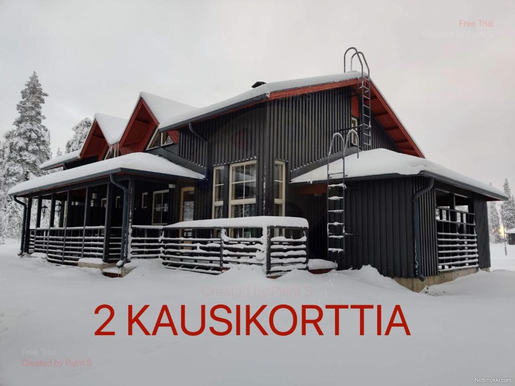 a building with snow on the ground in front of it at Tähtisara in Syöte