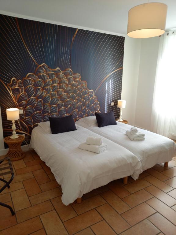 Postel nebo postele na pokoji v ubytování Hotel de la Halle