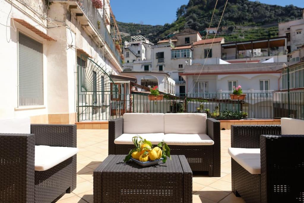 a table with a bowl of fruit on a balcony at Casa Teresina Minori Apartment in Minori